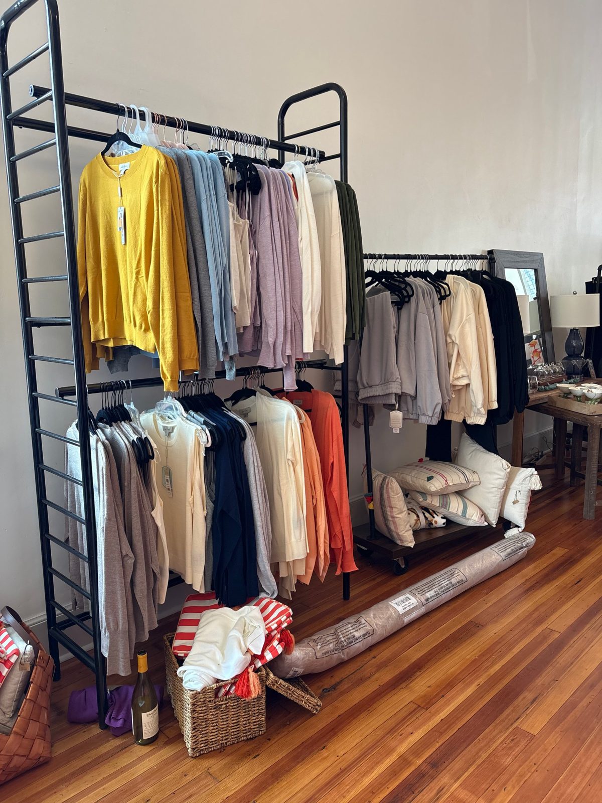 Sweaters and tops on a rack at Newtique